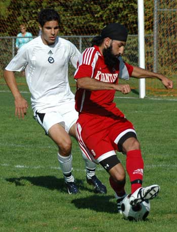 eagles-210908 Kwantlen's Sukhjinder Chahal attempts to manouvre past a Capilano defender as the Eagles try to close a two-goal second-half deficit against the Blues. (Dave Pires photo)