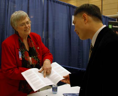 natropathic-medacine Sue Sparlin gives Daniel Lin information on the Boucher Institute for Natropathic Medacine.