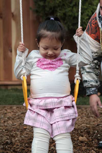 girlswing The littlest Yule takes her first ride on her new swing set. The entire family was stunned by the work of the Kwantlen Horticulture students. (Mitch Thompson photo)