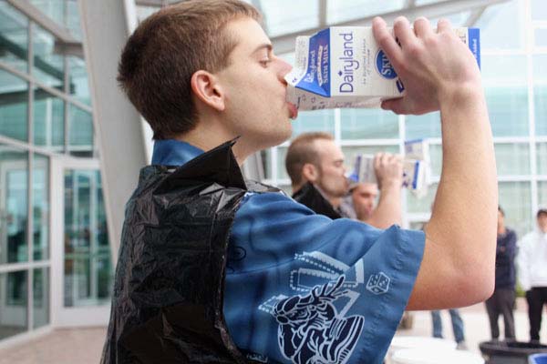 Milk-drinking competition. It’s bottom’s up for Kloeble as he tilts the carton back and chugs, keeping up with the contestants next to him. (Jacob Zinn photo)