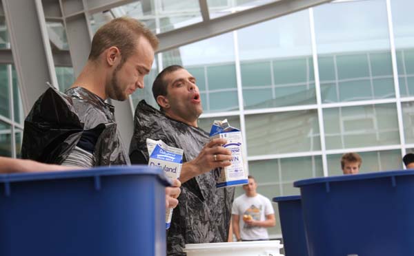 Milk-drinking competition. Johnson has some trouble stomaching the milk. He later dropped out of the competition. (Jacob Zinn photo)