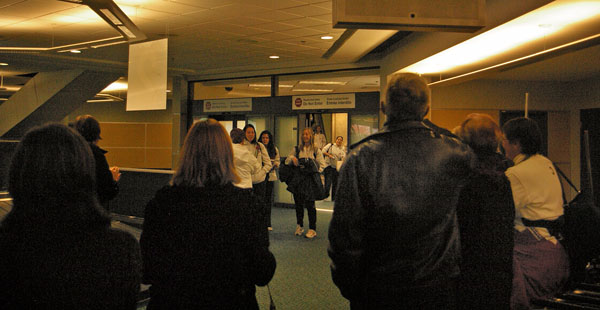 coming-in The parents of the Kwantlen women's soccer team crowd around the arrivals door as the team comes home.