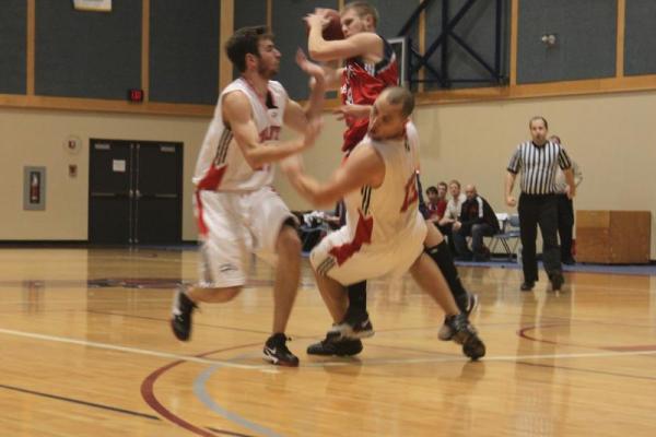 Kwantlen Eagles at Columbia Bearcats. Kenny Ryan falls to the court as he and Mike Davis block Tyler Anderson's drive. (Jacob Zinn photo)