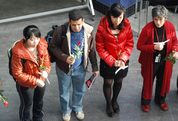 memory A small group of students stands quiety in memory of the 14 women killed. (Kim Ytsma photo)