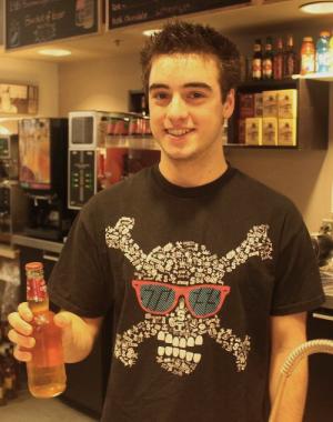 Sebastien Bergeron of the Grassroots Cafe. Sebastien Bergeron displays a bottle of Sleeman's at the Grassroots Cafe. (Jacob Zinn photo)