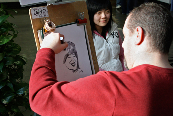 potrait-with-caption4 Kwantlen alumni Cory Van Ieperen of Corycatures puts the finishing touches on a portrait of a current student. (Kyle Vinoly Photo)