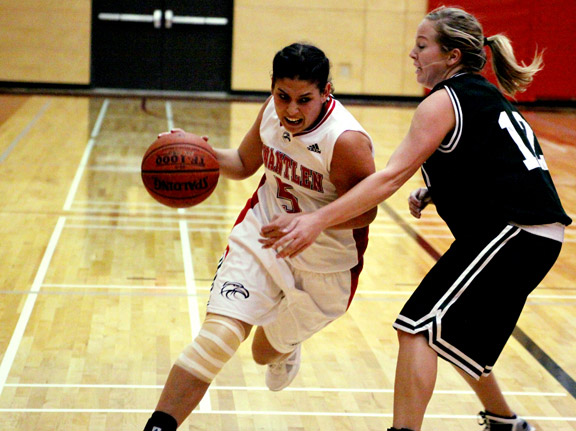 feb5-womens-drive Emily Wright powers past Quest Kermodes guard Brittany Harteveld in the third quarter, earning the Eagles a 40-31 lead over the Kermodes. (Justin Langille photo)
