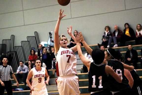 feb5-womens-throw Ali Randa throws a shot above Kermodes guard Charlotte Lau and forward Courtney Harpur, giving the Eagles a 49-38 advantage at the end of the third quarter. (Justin Langille photo)